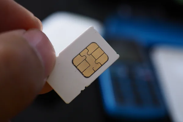 close-up-hand-holding-sim-card-and-put-into-smart-2022-01-12-20-37-13-utc